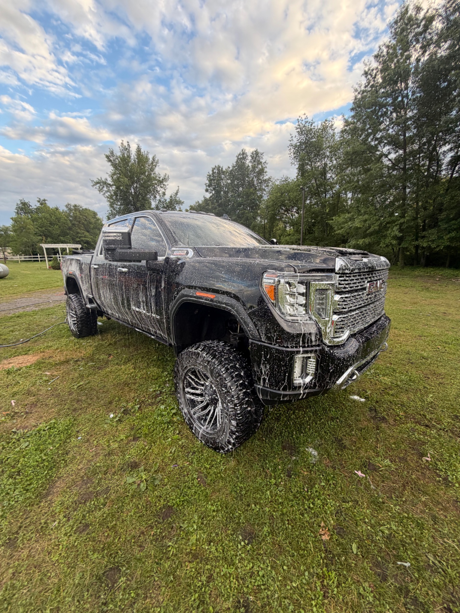 GMC pickup covered in foam during an exterior wash